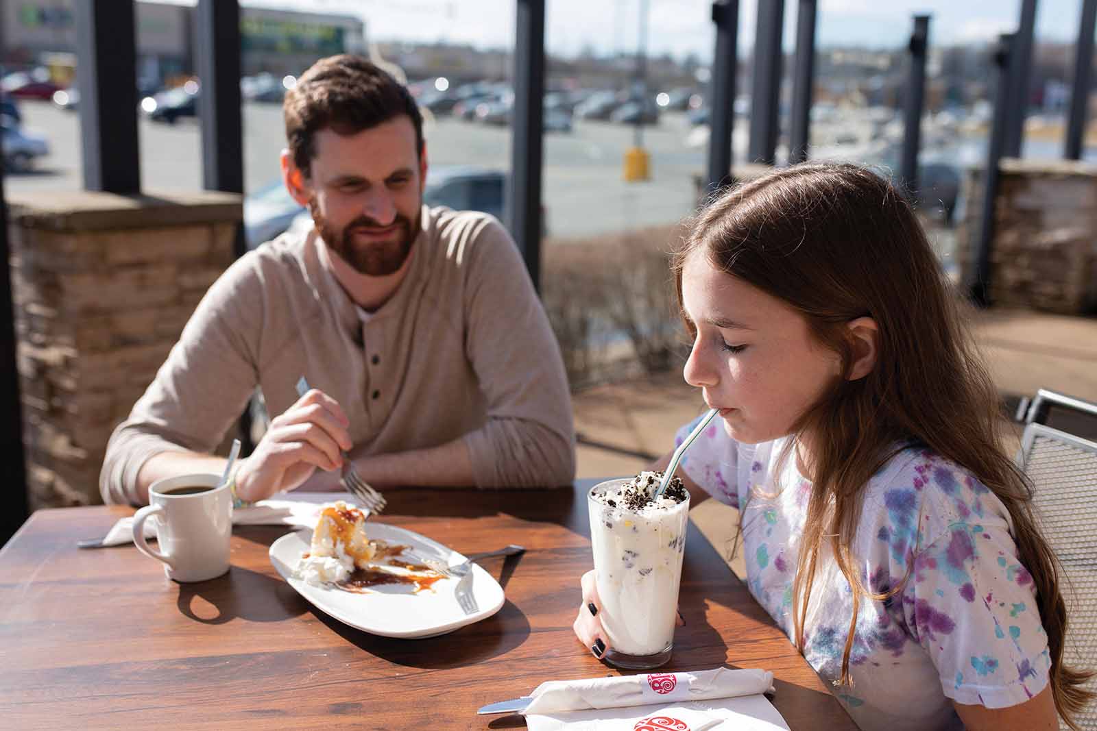 Father and daughter enjoying a treats on a Sackville patio