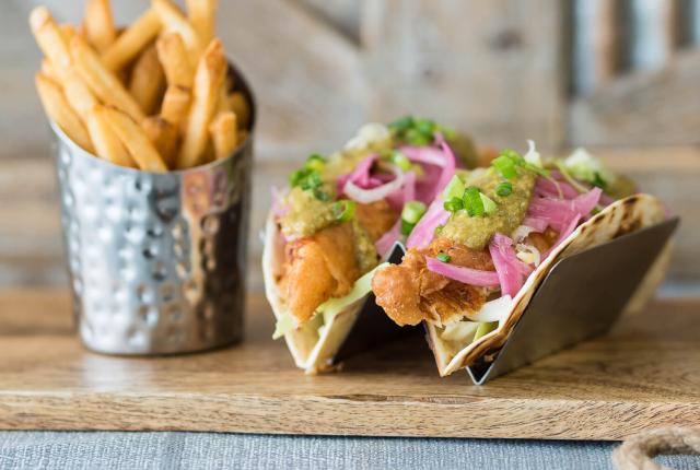 Tacos and fries on a board