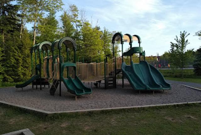 A playground surrounded by gravel.