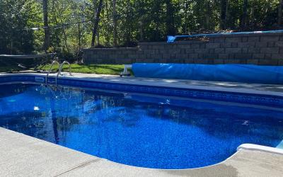 An inground pool surrounded by deck.