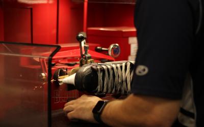 Person sharpening a hockey skate blade.
