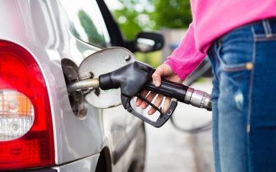 Person filling up on fuel at the pump.