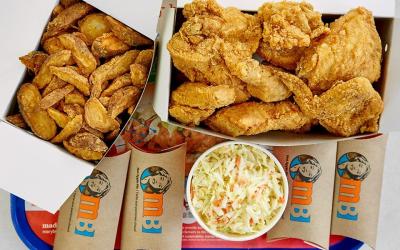 Mary Brown's Signature Chicken and taters in branded boxes served on a plastic tray.