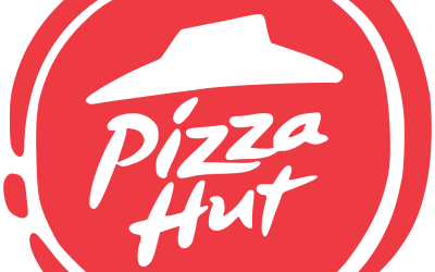 The Pizza Hut logo in white on top of a red circle. The Pizza Hut logo consists of handwritten type with a roof on top of the text.