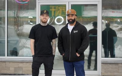 The owners standing outside the business.