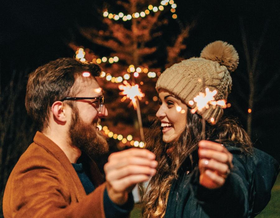 Couple holding sparklers at Light Up The Park