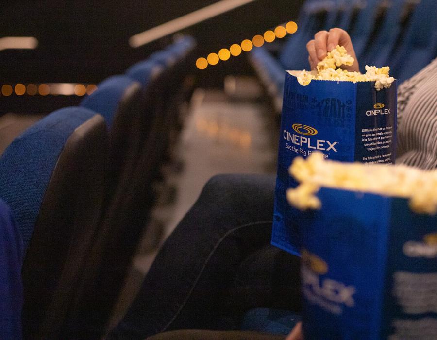 Someone eating popcorn at Cineplex
