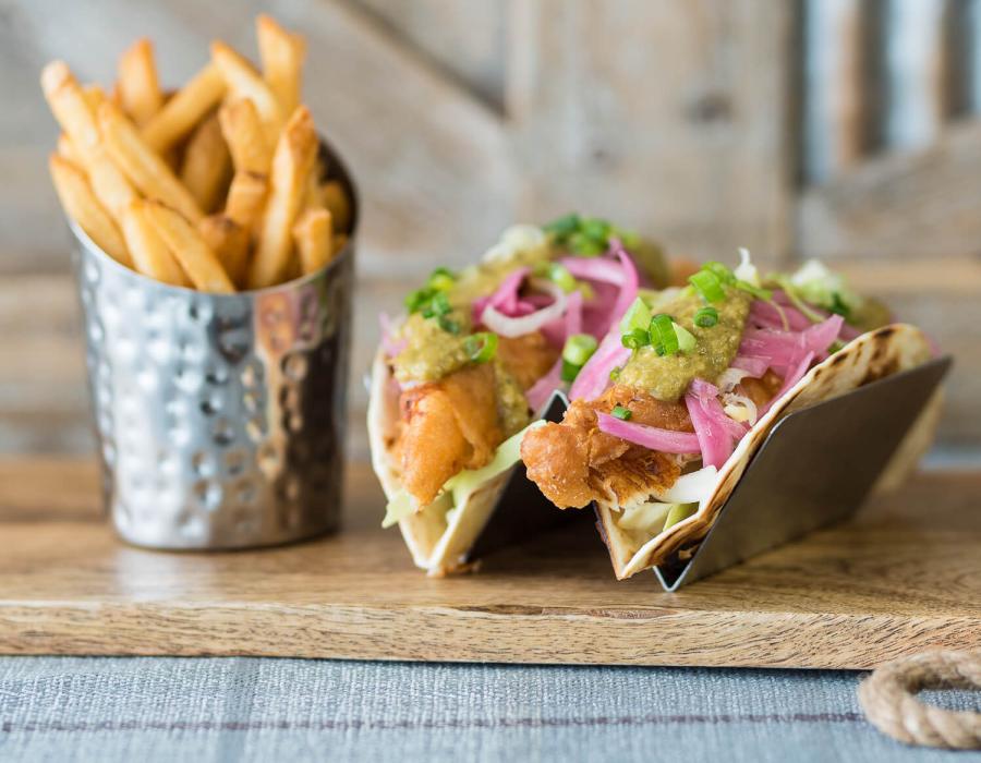 Tacos and fries on a board